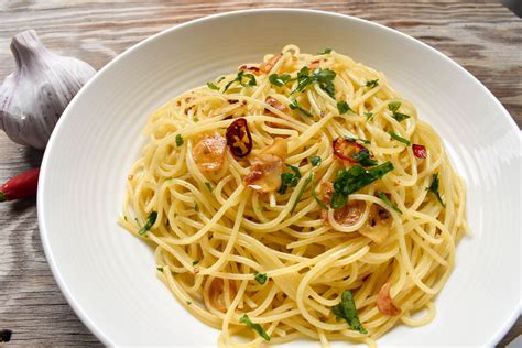 Misky s čerstvo pripravenými špagetami Aglio, Olio e Peperoncino s čili a petržlenovou vňaťou