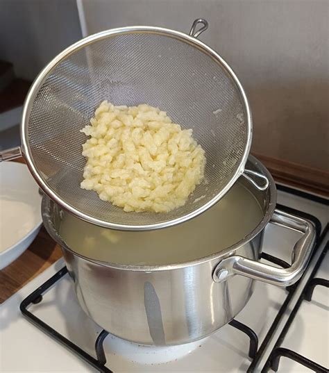 čerstvé uvarené halušky v sitku nad pariacim sa hrncom
