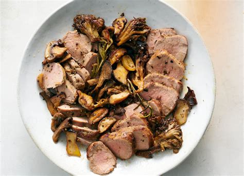 Plated pork tenderloin with porcini mushroom sauce and roasted potatoes