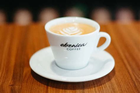 Šálka cappuccina s latte artom a pripraveným espressom