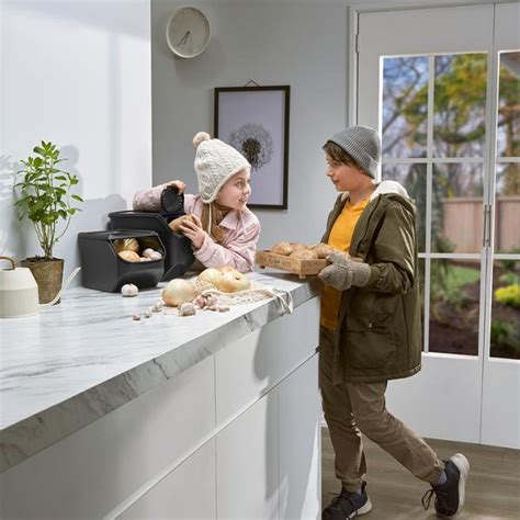 Ruky krájajúce cesnak a cibuľu na kuchynskej doske